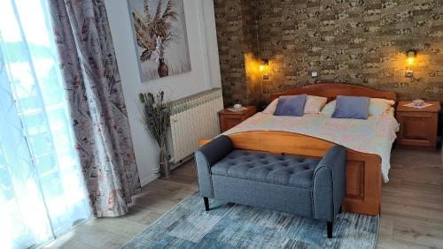 a bedroom with a bed and a blue chair at Apartment ŠTIZ by the sea with an organized beach in Betina