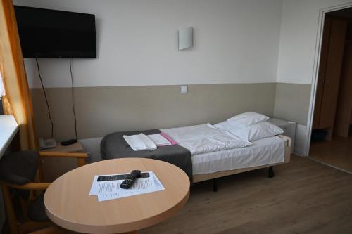 a small room with a bed and a table at SP ZOZ Sanatorium Uzdrowiskowe MSWiA w Kołobrzegu in Kołobrzeg