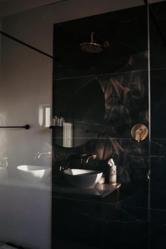 a bathroom with two sinks and a mirror at Lucky Crane Villas in McGregor