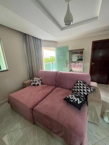 a couch in a living room with pillows on it at Casa bosque in Papuda