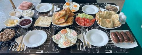 a table topped with plates and bowls of food at Shushabandi Kazbegi in Stepantsminda