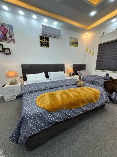 a bedroom with a bed with an orange blanket at Jerash City View in Jerash