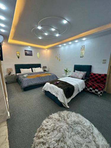 a bedroom with two beds and a rug at Jerash City View in Jerash