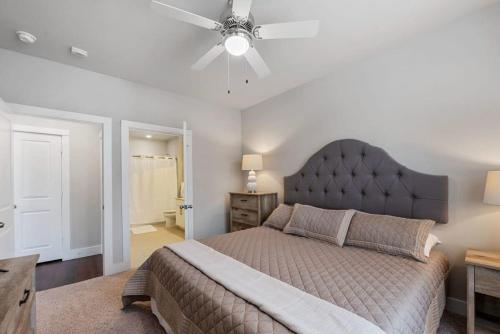 a bedroom with a large bed and a ceiling fan at Luxury 1 BR in the heart of Sugar Land w Pool in Sugar Land