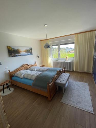 a bedroom with a bed and a large window at Haus Bergblick in Villach