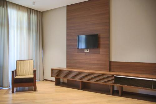 a room with a flat screen tv on a wall at Nina Palace Hotel in Tbilisi City