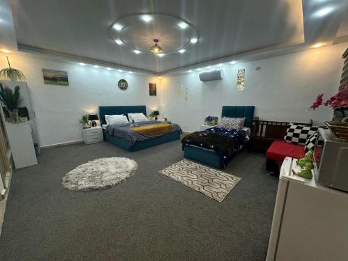 a living room with a bed and a couch at Jerash City View in Jerash