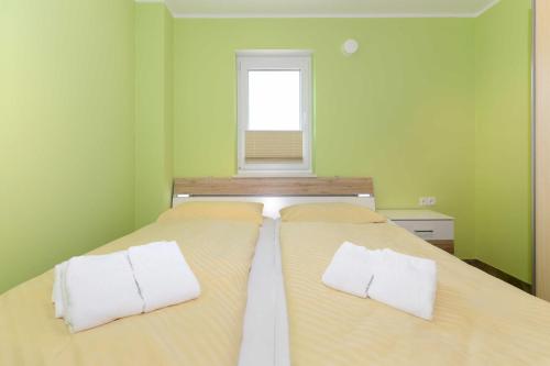 a bedroom with a bed with two pillows on it at Residenz Waterkant in Bensersiel
