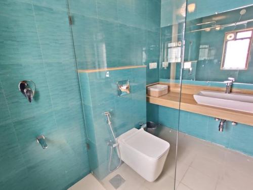 a bathroom with a toilet and a sink at Stelliam's Chic 2 Bhk Sea View Apartment in Goa in Panaji