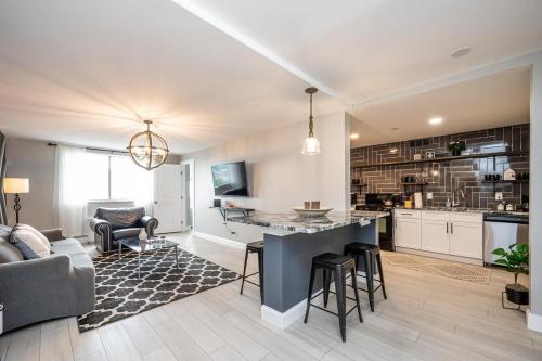 a living room with a couch and a kitchen with a table at ATL Downtown 2BR King Bed Free Parking LM1003 in Atlanta