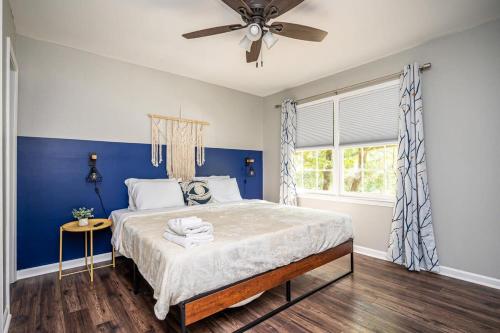 a blue bedroom with a bed and a ceiling fan at NEW ENTIRE PLACE Cozy 2B2B with King Bed SP1263 in Norcross