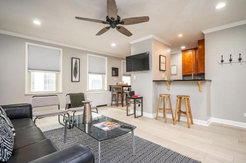 a living room with a couch and a ceiling fan at Downtown! 24h Concierge! Private Balcony! 11K in Atlanta