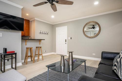 a living room with a couch and a ceiling fan at Downtown! 24h Concierge! Private Balcony! 11K in Atlanta