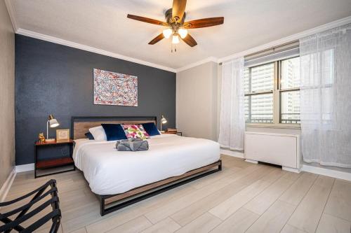 a bedroom with a bed and a ceiling fan at Downtown! 24h Concierge! Private Balcony! 11K in Atlanta