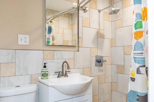 a bathroom with a sink and a mirror and a toilet at Downtown! 2BD City view Onsite Parking King LM809 in Atlanta