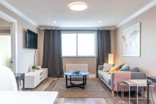 a living room with a couch and a table at Downtown 18th FL! City View& Onsite Parking LM1807 in Atlanta