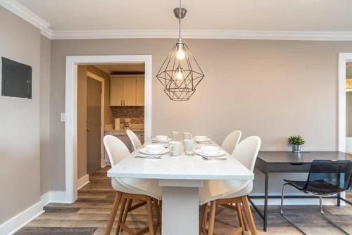 a dining room with a white table and chairs at Downtown 18th FL! City View& Onsite Parking LM1807 in Atlanta