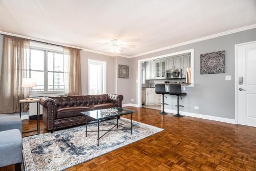 a living room with a leather couch and a table at ENTIRE CONDO! Downtown! 24 Concierge! PT9B in Atlanta