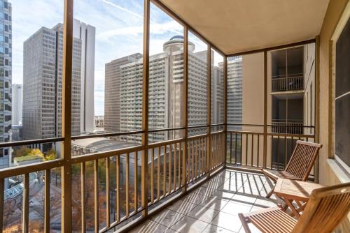 a balcony with two chairs and a view of the city at Downtown Condo! Private Balcony! 10F in Atlanta