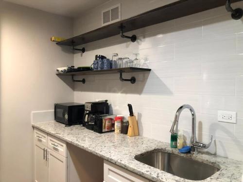 a kitchen counter with a sink and a microwave at Downtown Condo! Private Balcony! 10F in Atlanta