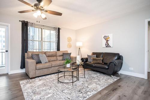 a living room with a couch and a ceiling fan at ATL Downtown Private Balcony 24h Concierge PT6F in Atlanta