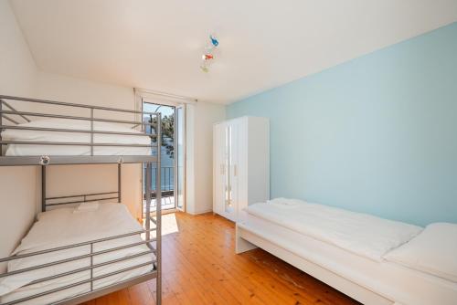 a bedroom with two bunk beds and a ladder at Brissago Lake Apartment in Brissago