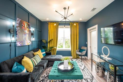 a living room with blue walls and a couch at Downtown New Built Roof top balcony City View 525Pkwy in Atlanta