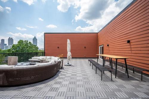 a patio with a table and a umbrella on a building at Downtown New Built Roof top balcony City View 525Pkwy in Atlanta