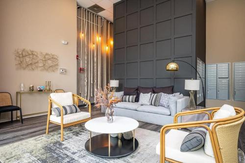 a living room with a couch and chairs and a table at Downtown New-Built Roof-top balcony City View 525Pkwy in Atlanta