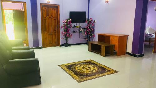 a living room with a couch and a table at SNP Star Guest House in Trincomalee