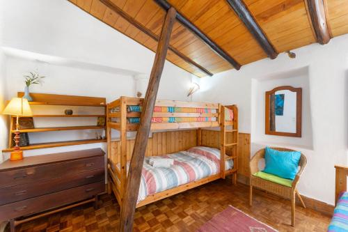 a bedroom with a bunk bed and a desk at Sagres, Aloha Beach House, 500 meters from Tonel beach in Sagres