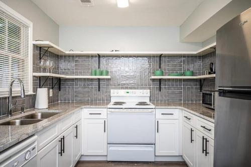 a kitchen with white cabinets and a white stove top oven at NEW ENTIRE PLACE COZY QUIET 2b2b TOWNHOUSE SP1277 in Norcross