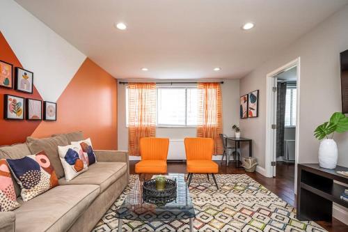 a living room with a couch and two orange chairs at ATL Downtown 2BR King Bed Free Parking LM808 in Atlanta