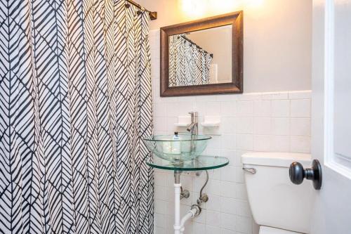 a bathroom with a sink and a mirror and a toilet at Downtown Atl Condo Onsite Parking King bed & bonus room LM1901 in Atlanta
