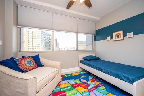 a bedroom with a bed and a couch and a window at Downtown Atl Condo Onsite Parking King bed & bonus room LM1901 in Atlanta