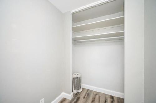 a walk in closet with white walls and wood floors at Atlanta Downtown City View Condo Free Parking LM1606 in Atlanta