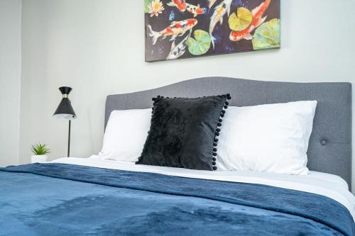 a bed with a blue blanket and white pillows at 2BR Chic Downtown ATL Condo w Free Parking LM602 in Atlanta