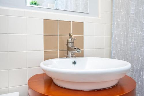 a white sink on a wooden table in a bathroom at 2BR Chic Downtown ATL Condo w Free Parking LM602 in Atlanta