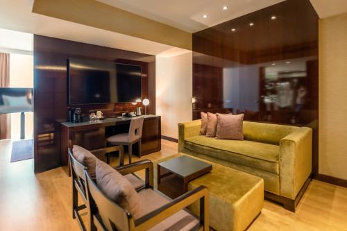 a living room with a couch and a table at Hyatt Regency Barcelona Tower in Hospitalet de Llobregat