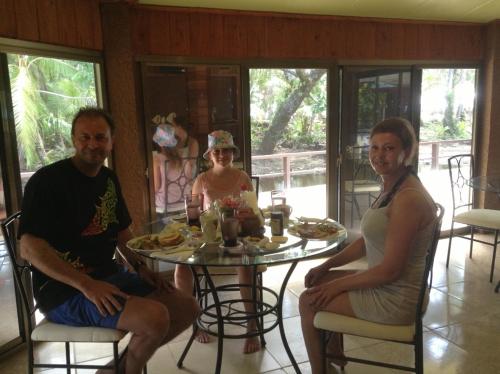 a group of people sitting around a table at M&A Riverside Beach Bungalows in Chol