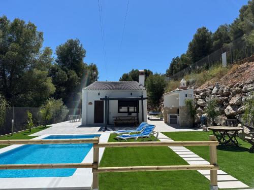 a villa with a swimming pool and a house at La Casona del Pinar Swiming Pool in Alhaurín de la Torre