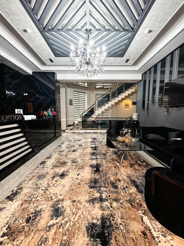 a lobby with a large marble floor and a chandelier at De Villa Hotel in Samarkand