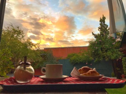 a table with a plate of bread and a cup of coffee at Hotel Francia in San Rafael