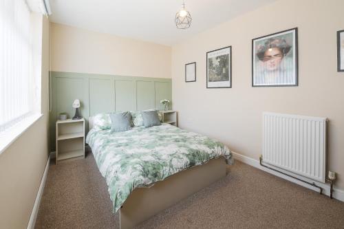 a bedroom with a bed with blue pillows at Poppy's Place - Manningham Road in Liverpool