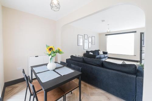a living room with a couch and a table at Poppy's Place - Manningham Road in Liverpool