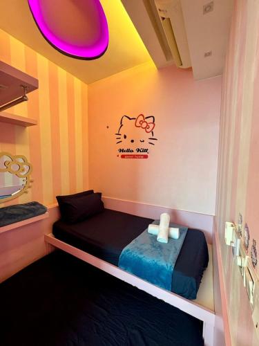 a room with a bed with a pig sticker on the wall at SA Sutera Avenue Homestay Opposite Imago KK in Kota Kinabalu