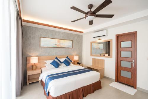 a bedroom with a bed and a ceiling fan at Ayala Oceanview Maldives in Gulhi