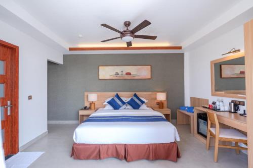 a bedroom with a bed with a ceiling fan at Ayala Oceanview Maldives in Gulhi