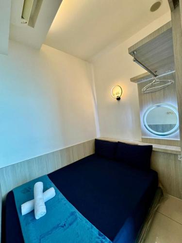 a small room with a blue bed with a white pillow at SA Sutera Avenue Homestay Opposite Imago KK in Kota Kinabalu