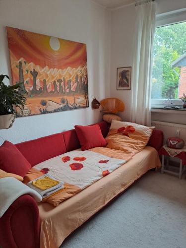 a couch in a living room with a bed at African Dream in Oldenburg